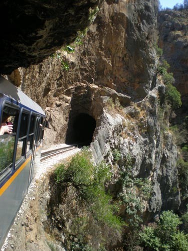 Underneath an overhang into another tunnel in the Diakofto rack and pinion railway © Yacht Balvenie